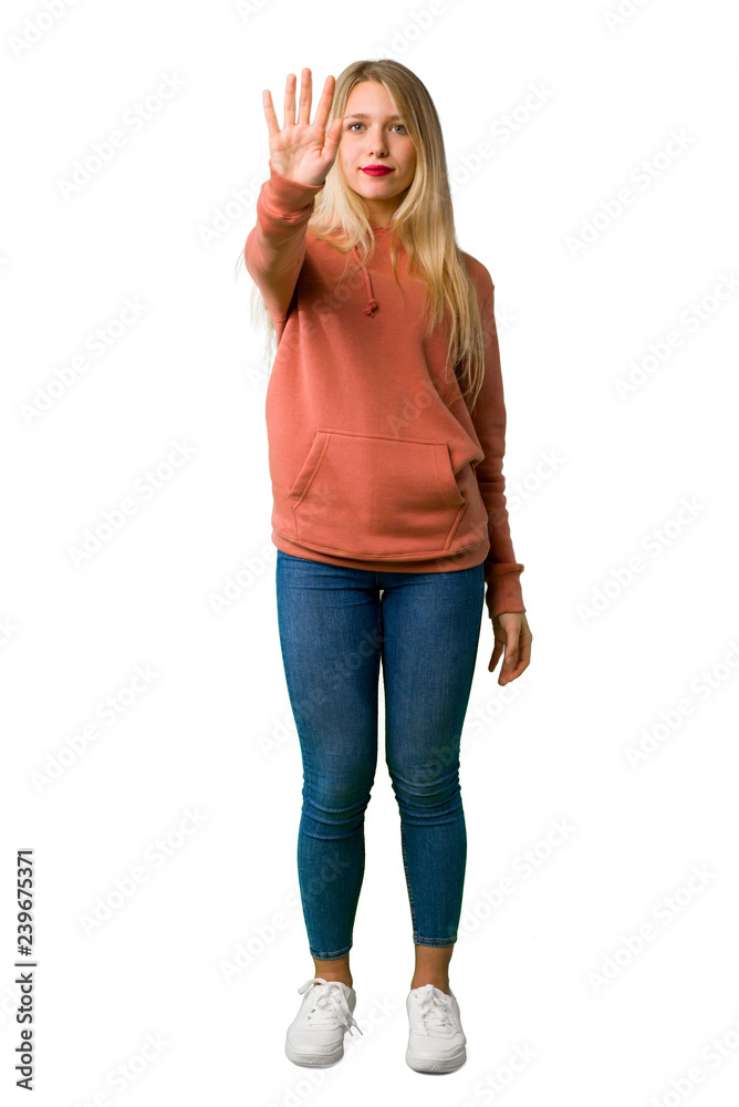 A full-length shot of a Young girl making stop gesture denying a situation that thinks wrong on isolated white background A full-length shot of a Young girl making stop gesture denying a situation that thinks wrong on isolated white background