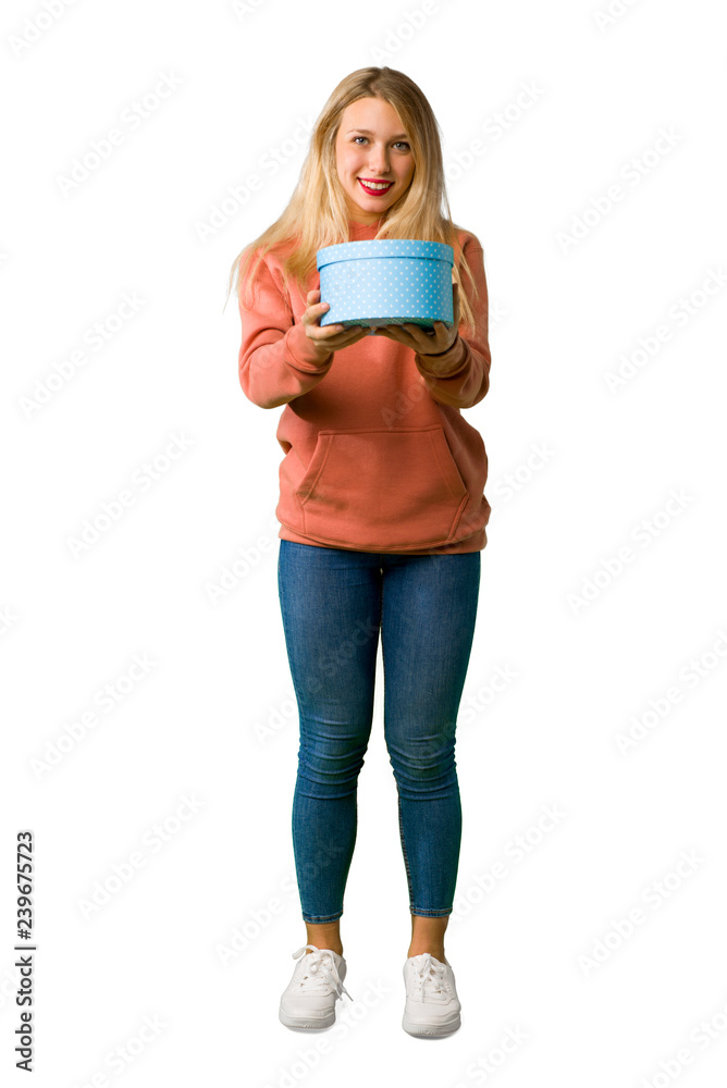A full-length shot of a Young girl surprised because has been given a gift on isolated white background