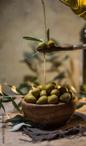 Virgin olive oil falling on a bowl photo