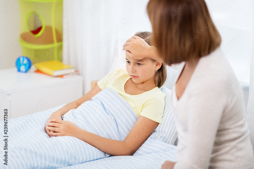 family, health and people concept - mother taking care of unhealthy daughter at home family, health and people concept - mother taking care of unhealthy daughter at home