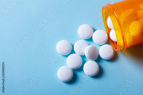 White pills on blue background photo