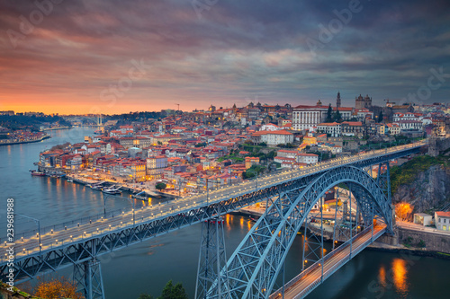 Porto, Portugal. Aerial cityscape image of Porto, Portugal with the famous Luis I Bridge and the Douro River during dramatic sunset.