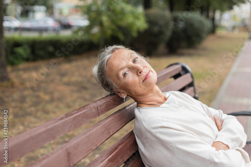 Portrait of senior woman relaxing on bench