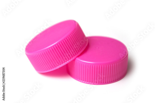 closeup of pink plastic plugs for recycling on white background
