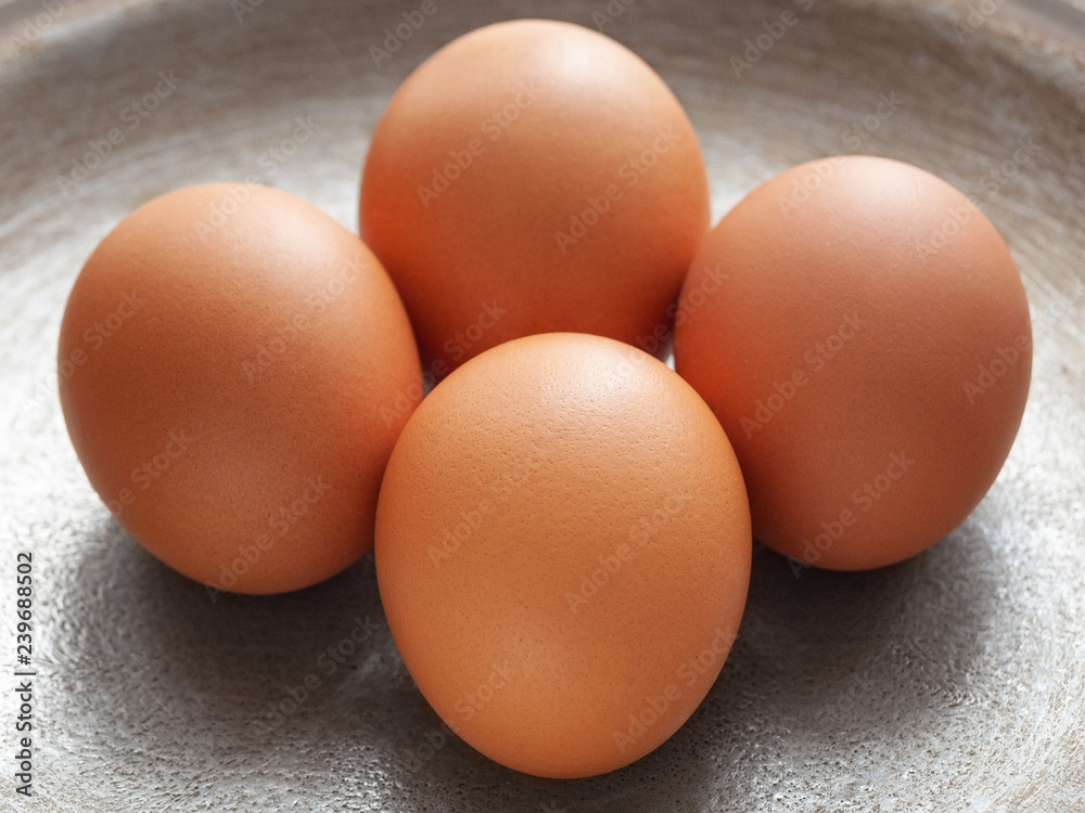 brown eggs on the background of a metal pan. brown eggs on the background of a metal pan.