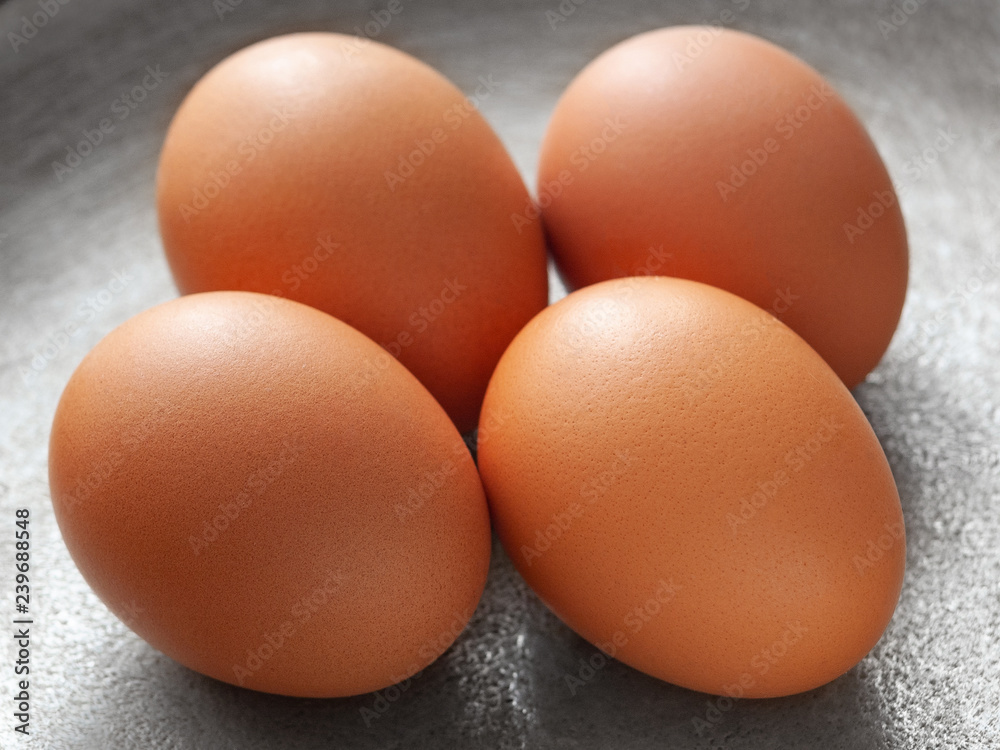 brown eggs on the background of a metal pan. brown eggs on the background of a metal pan.
