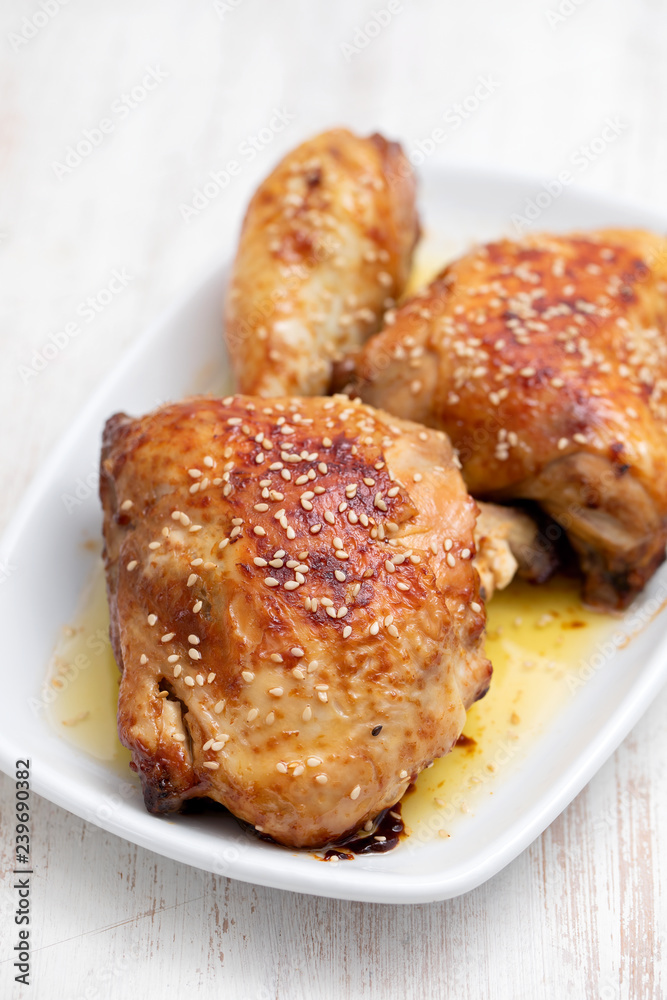 fried chicken with sauce and sesame on white dish fried chicken with sauce and sesame on white dish