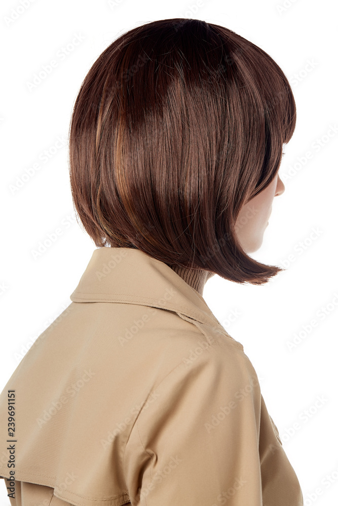 A close up back view side shot of a lady with dark brown short haircut,  wearing