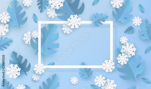 Vector illustration of blue winter natural banner - blue plant leaves and white snowflakes in paper art style around rectangle frame with empty space for text for seasonal design.