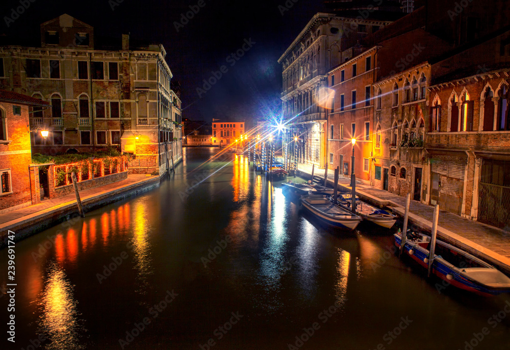 night scene in Venice with canal and boats 