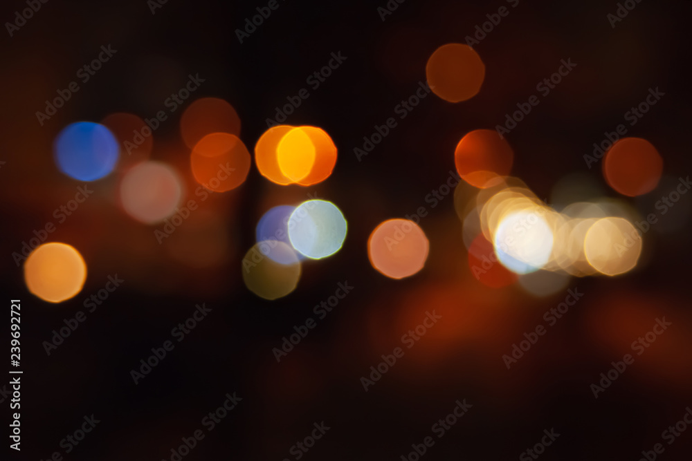 Fototapeta premium Blurred night background of city street road with bokeh effect. Abstract wallpaper for design and editing images.