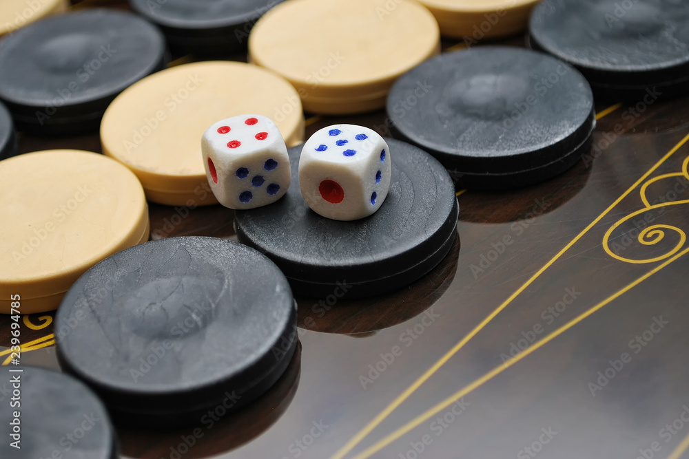 Backgammon Table Game Board. Color detail of a Backgammon game with two dice. Board game backgammon. Selective focus Backgammon Table Game Board. Color detail of a Backgammon game with two dice. Board game backgammon. Selective focus