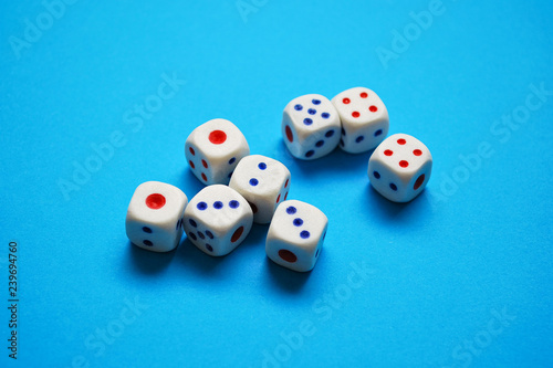 White dices on blue background. Selective focus