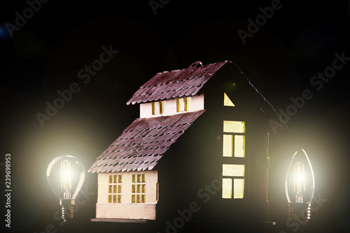 Led lamps near the house layout on a black background