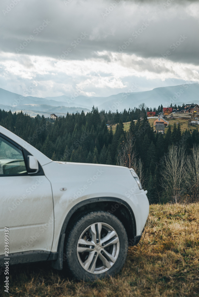 Fototapeta premium white suv car car travel concept mountains on background
