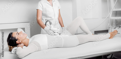 Beautiful woman receiving lpg massage against cellulite photo