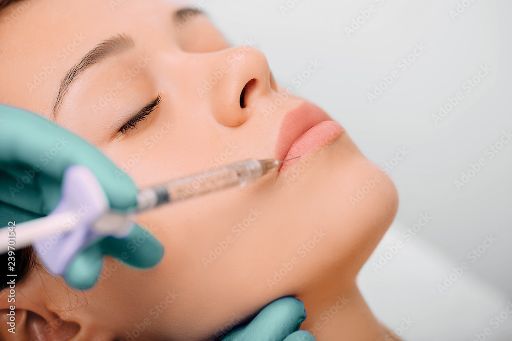 woman having lip injection for lip augmentation