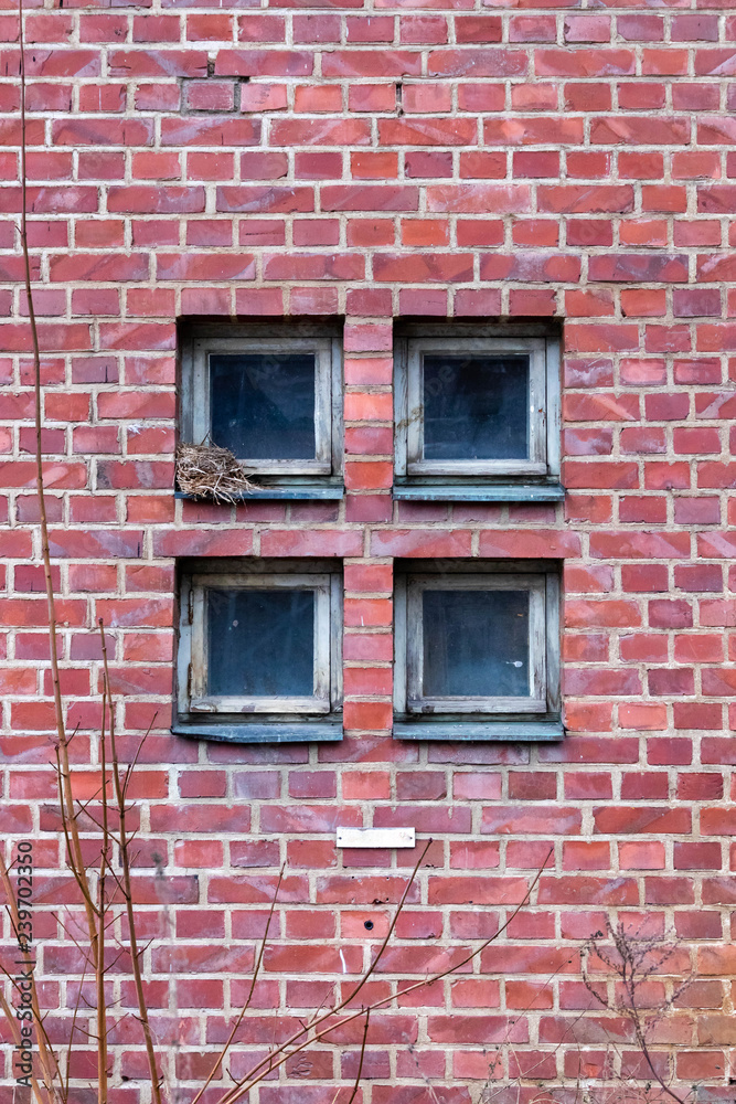 Four square windows on a brick wall