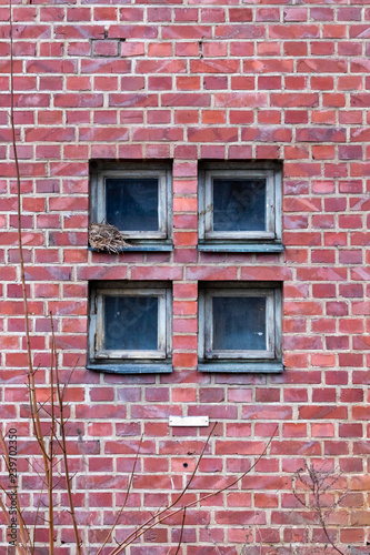 Four square windows on a brick wall
