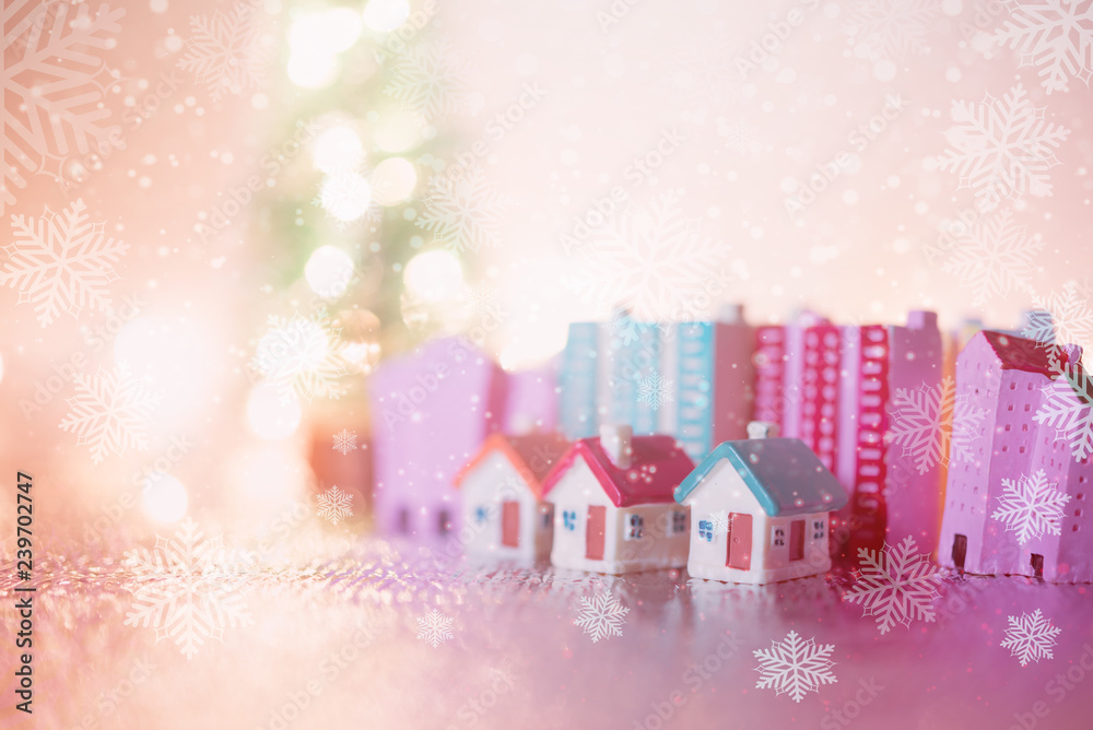 miniature house with blue roof on blurred Christmas decoration background.Image for property real estate investment concept