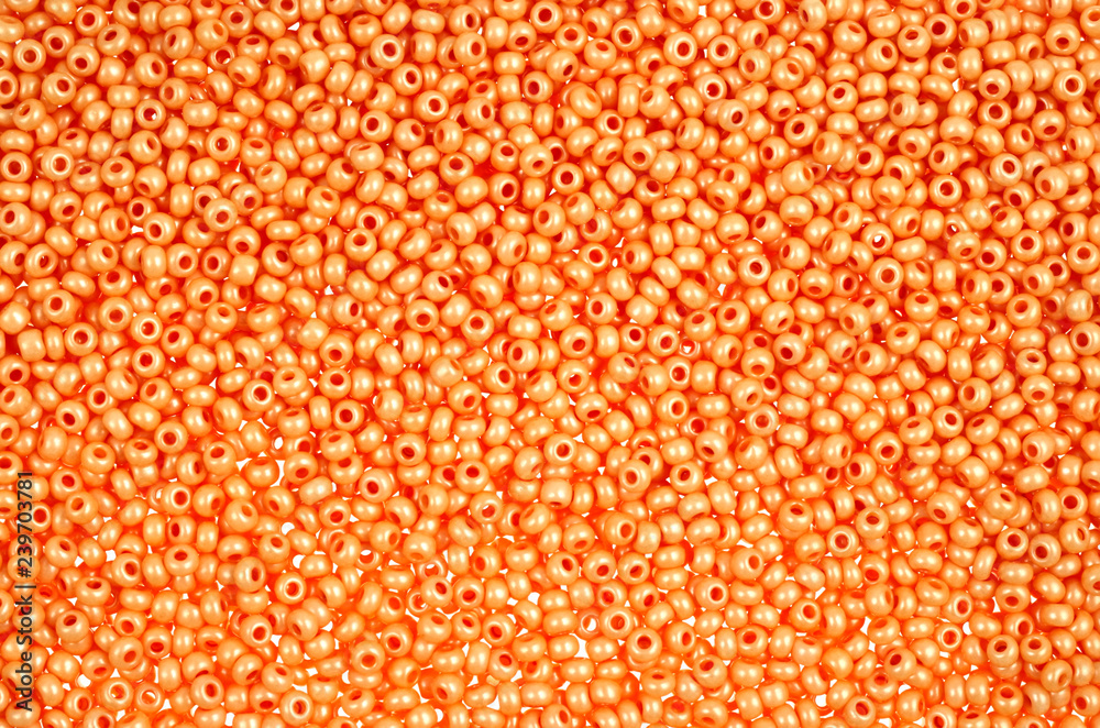 Flame-orange glass beads background - closeup beads texture
