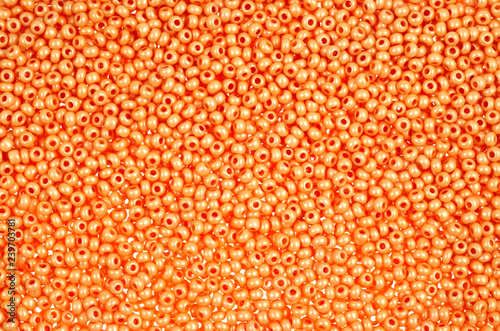 Flame-orange glass beads background - closeup beads texture
