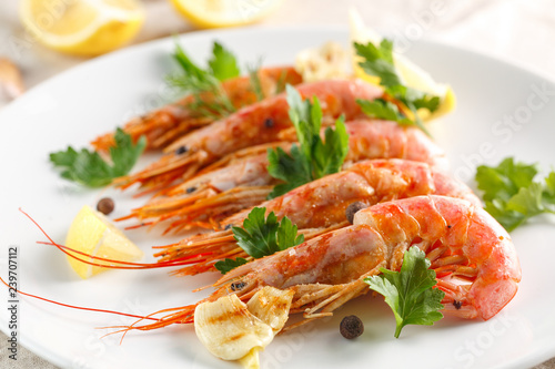 Grilled shrimps with spice, lemon and greenery. Grilled seafood.