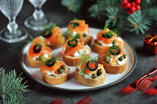 Canvas Print Canapes with cream cheese, salted salmon, capers, olives and dill