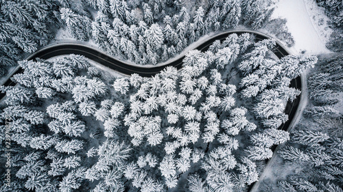Heart shaped road in snowy forest, winter from above © marcin jucha
