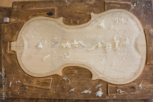 Crafting violin - detail of violin on table. Selective focus, top view.