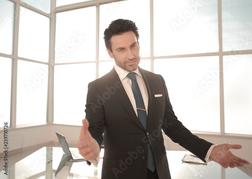 friendly businessman standing in his office.