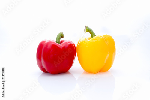 Couple of red and yellow bell pepper on isolate white background with copy space.