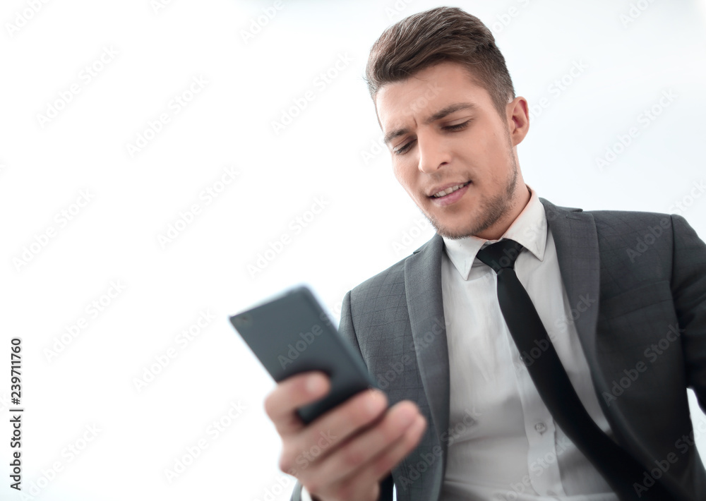serious businessman with phone reading message