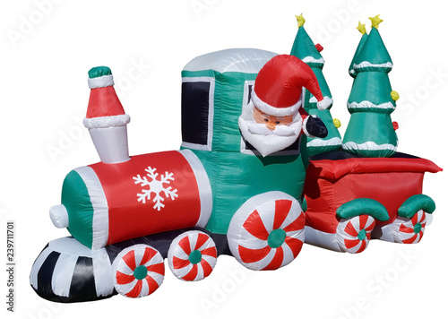 Isolated inflatable Santa train lawn decoration delivering Christmas trees.