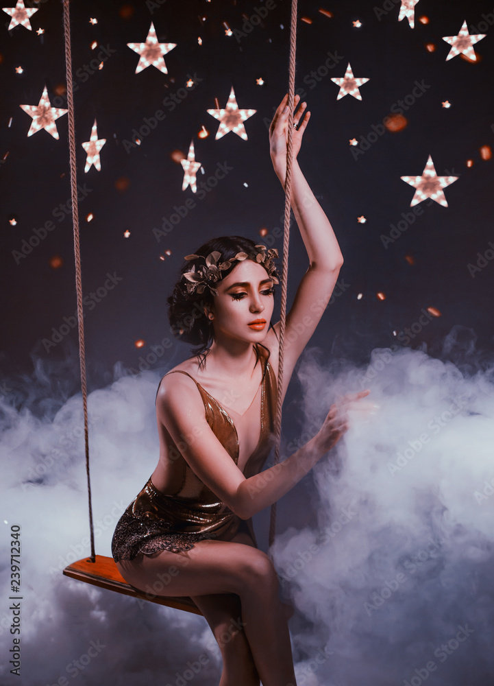 golden goddess of the night, amazing young girl with dark oxen and a wreath, in a short cocktail dress with a mesh, riding on a rocker, careful to touch the white clouds, fog, flooded the starry sky
