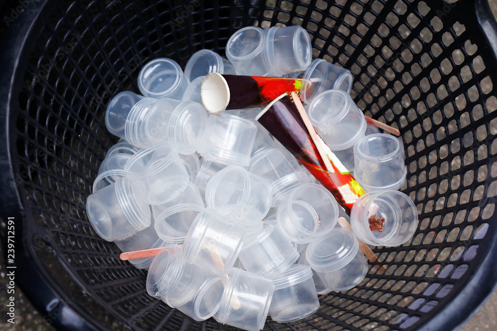 waste plastic cups many in basket, garbage plastic, plastic glass dirty, plastic  waste trash pollution in basket bin top view (selective focus) Stock Photo  | Adobe Stock
