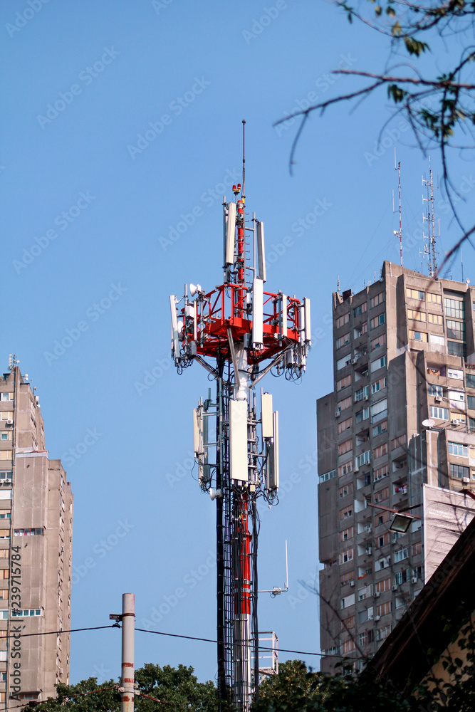 Telecommunication network repeaters, base transceiver station. Tower wireless communication antenna transmitter and repeater. Telecommunication tower with antennas. Cell phone telecommunication tower.