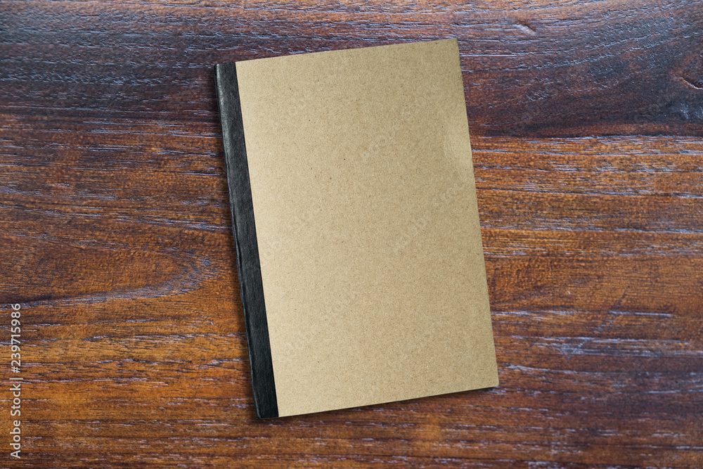 Book of brwon on wooden table top view angle, freelance and office Book of brwon on wooden table top view angle, freelance and office