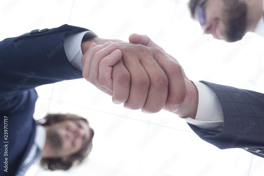 bottom view of two men shaking hands while standing