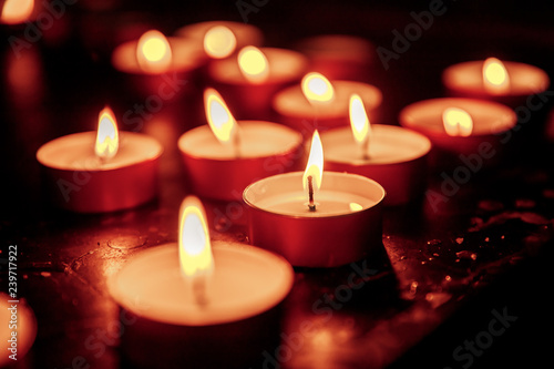 Close-up candles in catholic church stand row. Concept mourning, disaster dead.