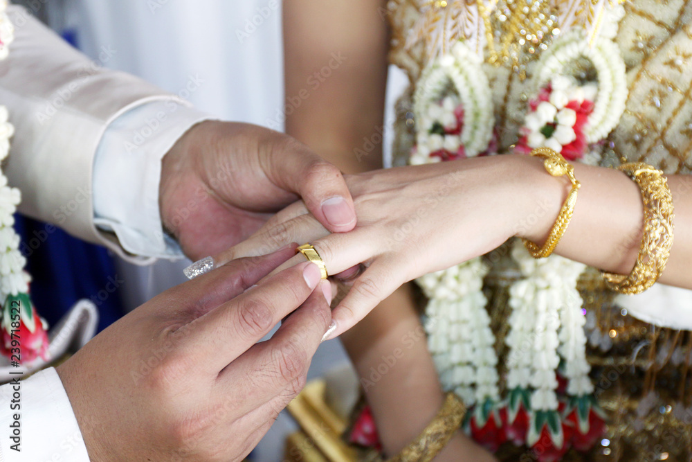marriage thai wedding rings, groom put the wedding ring on bride, bride put  the ring on groom, thai wedding ceremony and wedding decoration of thailand  original marriage Stock Photo | Adobe Stock