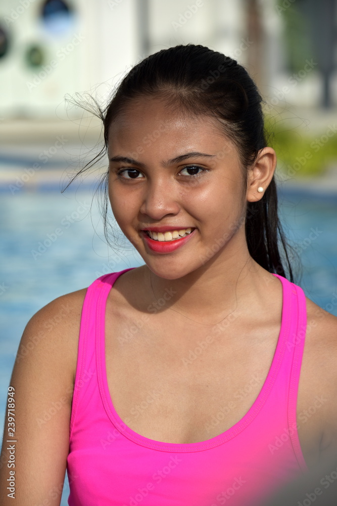 Cute Diverse Girl Teenager Smiling Sitting By Pool