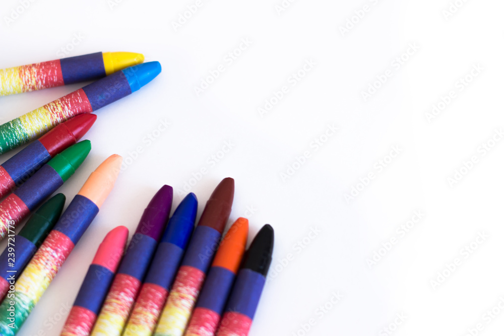 Fototapeta premium Colored wax pencils on a white background close-up