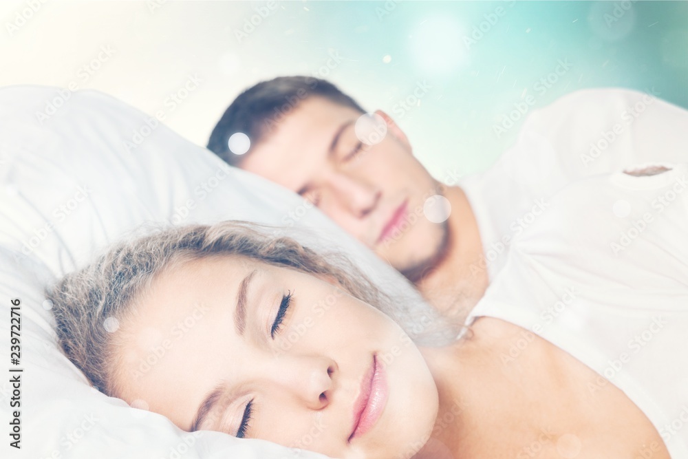 Young beautiful couple sleeping in white bed Young beautiful couple sleeping in white bed