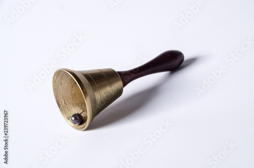 old hand bell made of brass with a wooden handle