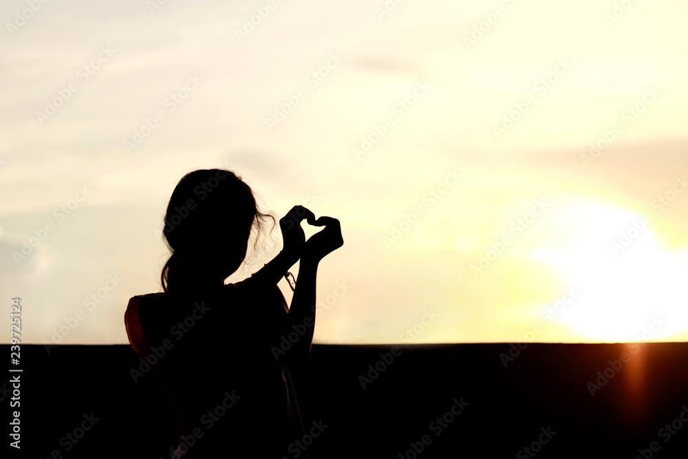 silhouette children marking love symbol with arms and hands over sunset, shadow image children in happy playing feel evening time, silhouette of child enjoy, kid joy playing silhouette feel in sunset