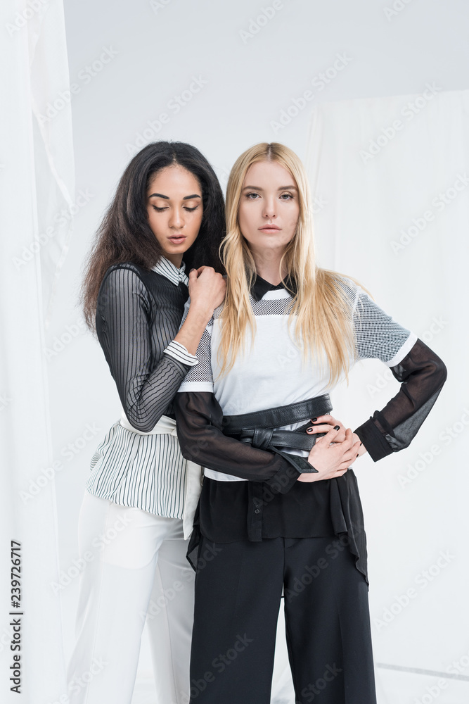 attractive multiethnic girls in black and white clothes posing isolated on white attractive multiethnic girls in black and white clothes posing isolated on white