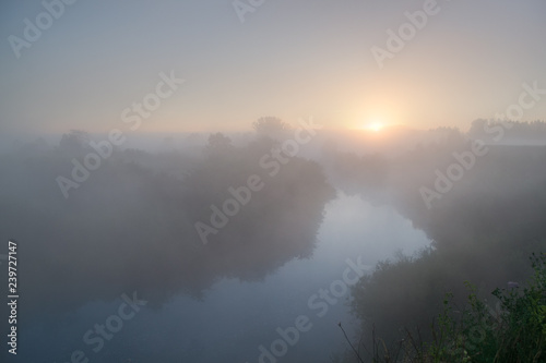 Morning landscape. Sunrise and very thick fog  Misty river. foggy morning