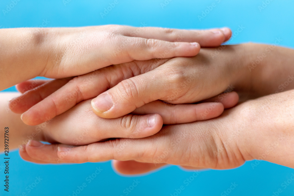 adult hands hug and protect the hands of a child. adult provides protection to the child. adult hands hug and protect the hands of a child. adult provides protection to the child.