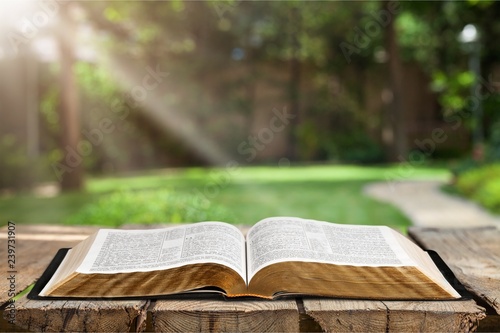 Open book on old wooden table